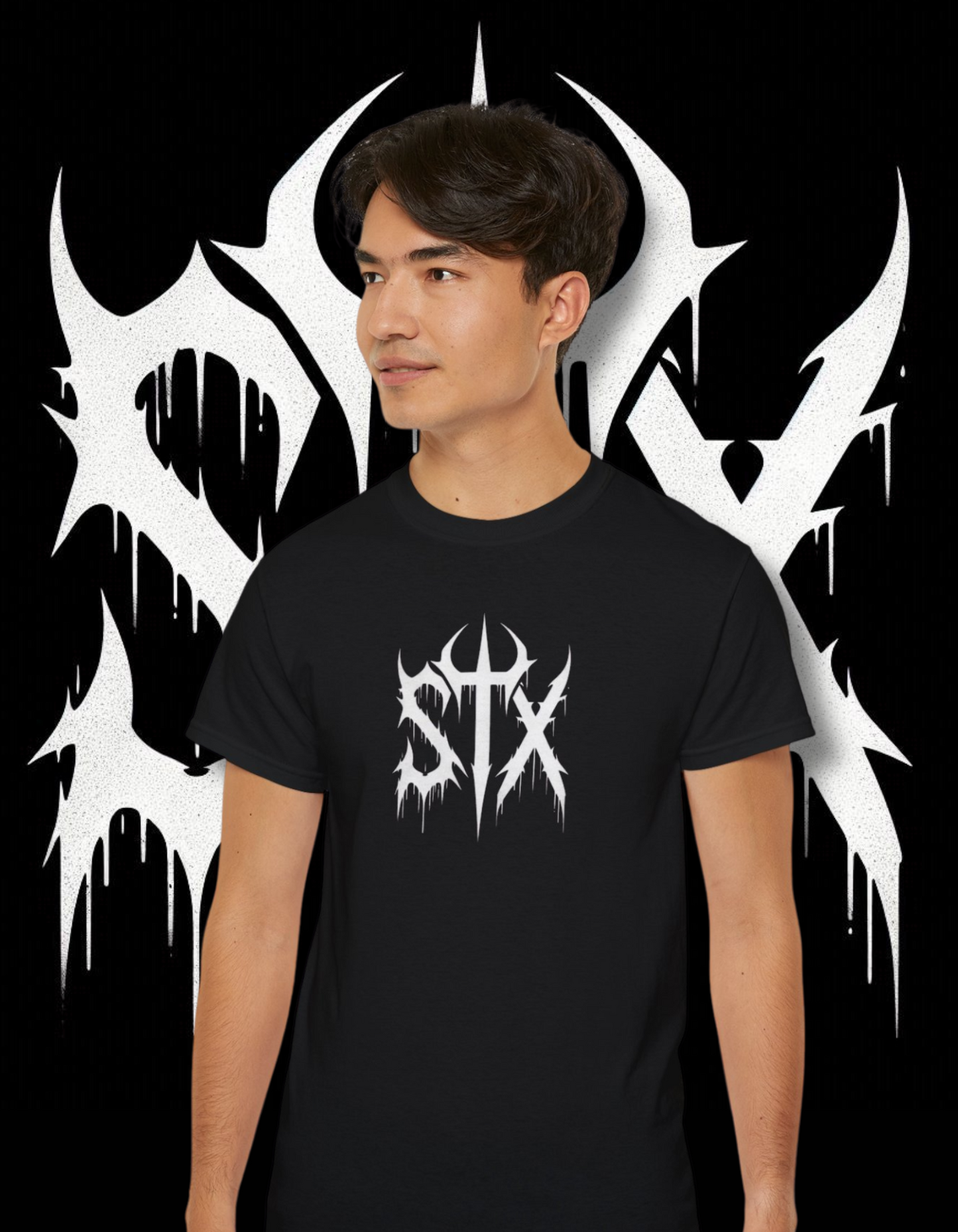 A person wearing a black 'STXSTX' t-shirt with a bold white graphic design resembling a heavy metal style with a slash.