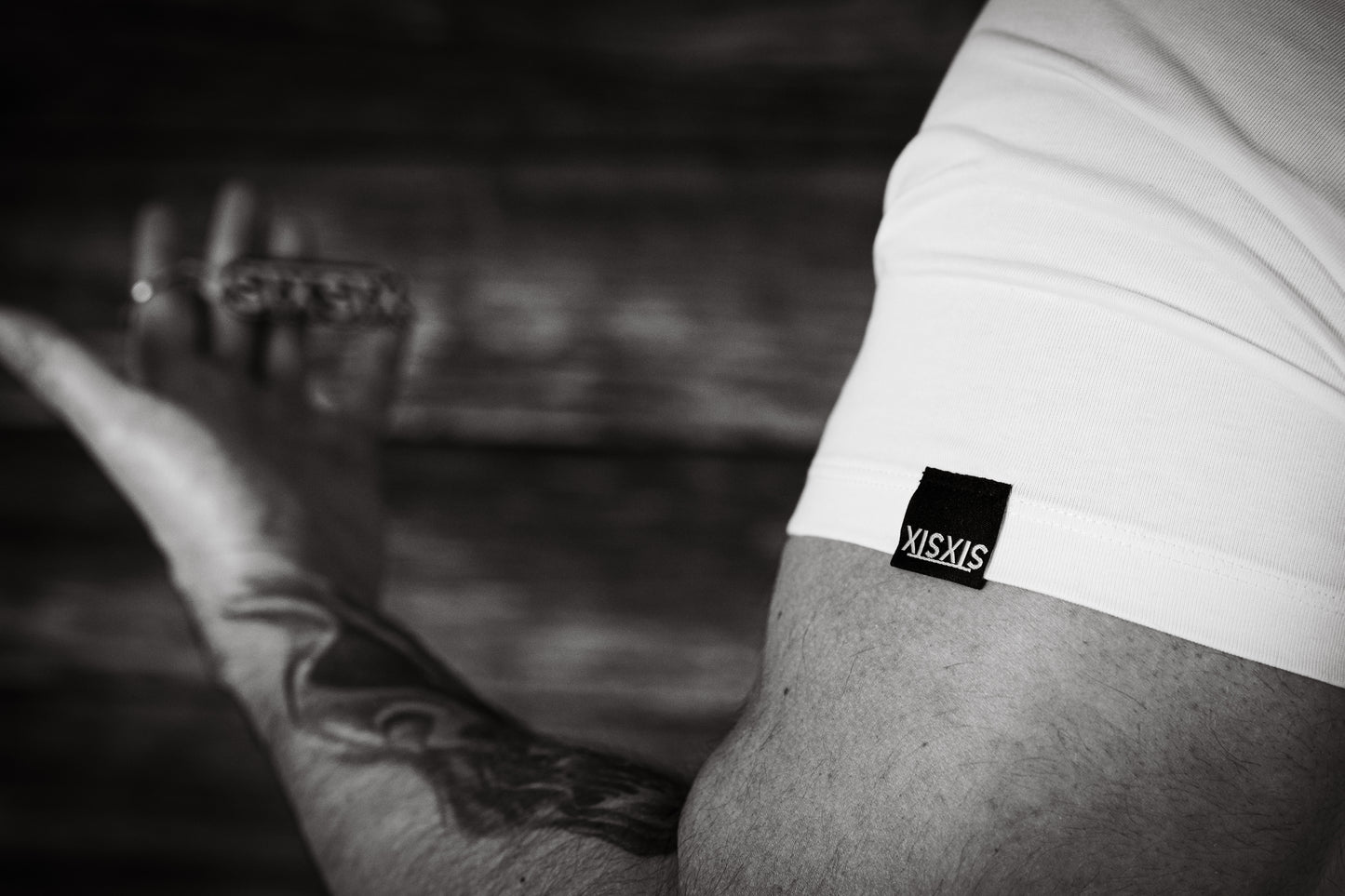 Close up of a hem tag on a t shirt sleeve with the STXSTX logo