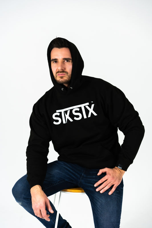 Person wearing a black hoodie with 'STXSTX' logo on a white background