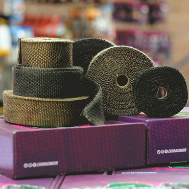 a bundle of Titanium and Carbon Exhaust Wrap ontop of an exoracing box
