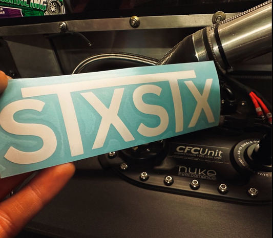 an stxstx sticker being held infront of a nuke performance fuel cell