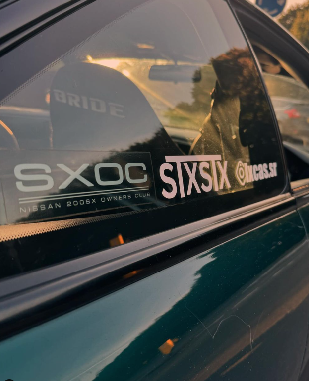 an stxstx sticker on the window of an nissan s14 silvia