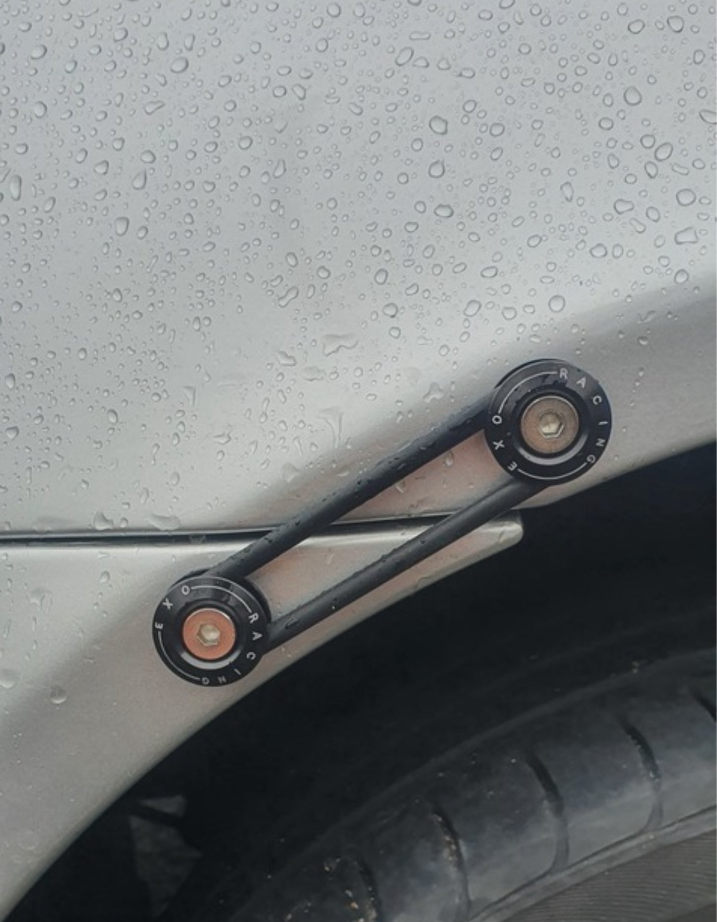 Set of black metal Bumper ties and black rubber rings on a grey mazda mx5 car