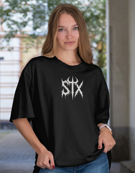 Woman wearing a black t-shirt with 'STXSTX' logo outdoors