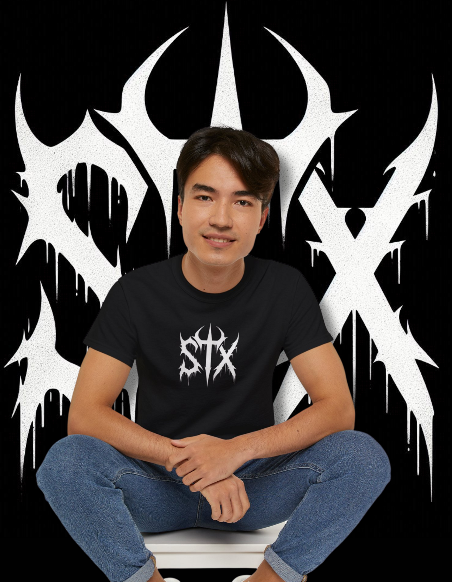 A person wearing a black 'STXSTX' t-shirt with a bold white graphic design resembling a heavy metal style with a slash.