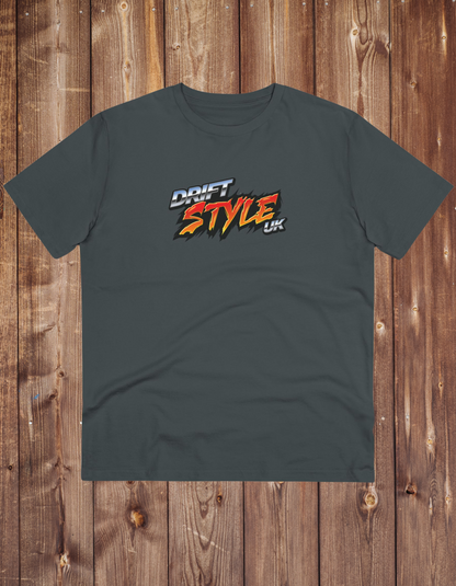 A grey unisex t-shirt with 'DRIFT STYLE UK' text on the front, displayed on a wooden background.