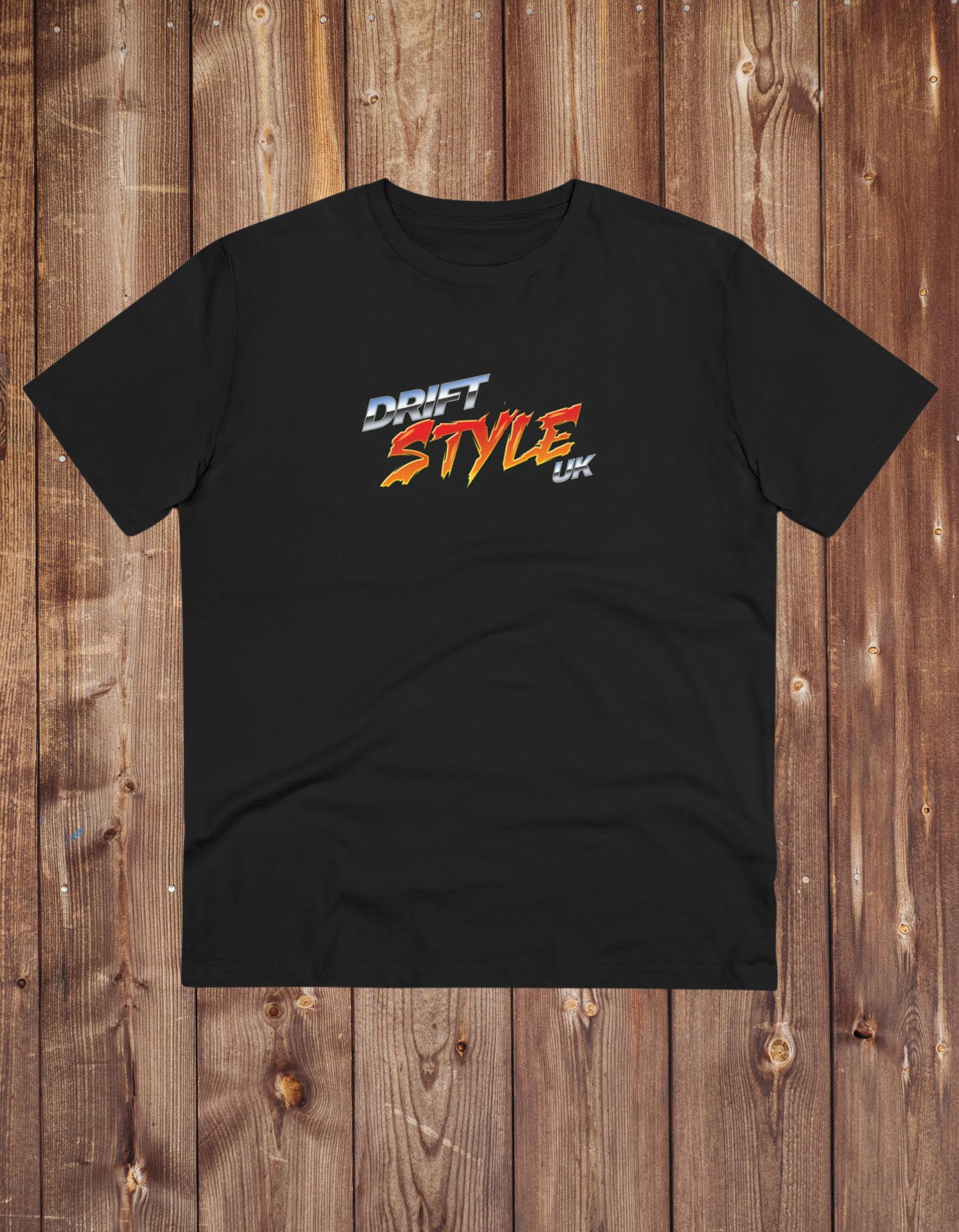 A black unisex t-shirt with 'DRIFT STYLE UK' text on the front, displayed on a wooden background.