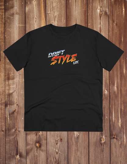 A black unisex t-shirt with 'DRIFT STYLE UK' text on the front, displayed on a wooden background.