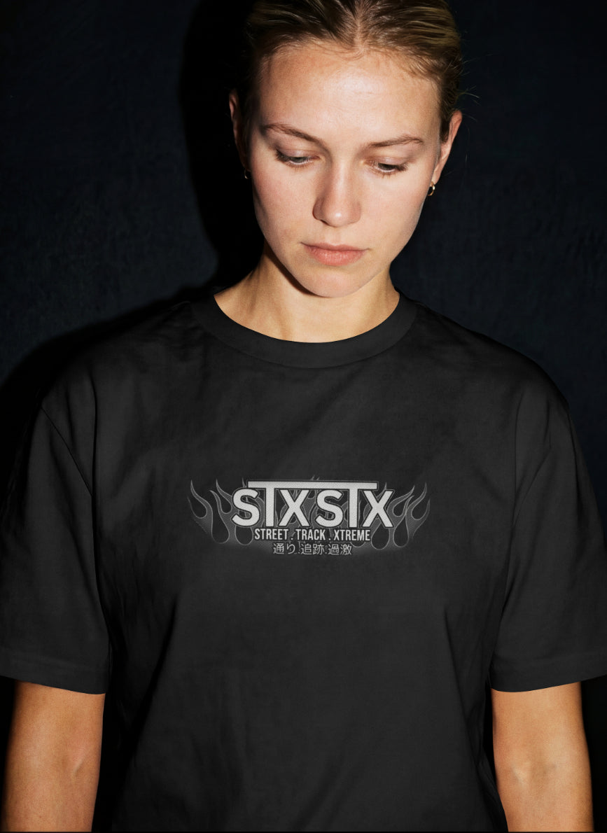 female model wearing premium black stxstx tshirt with stxstx logo on the front