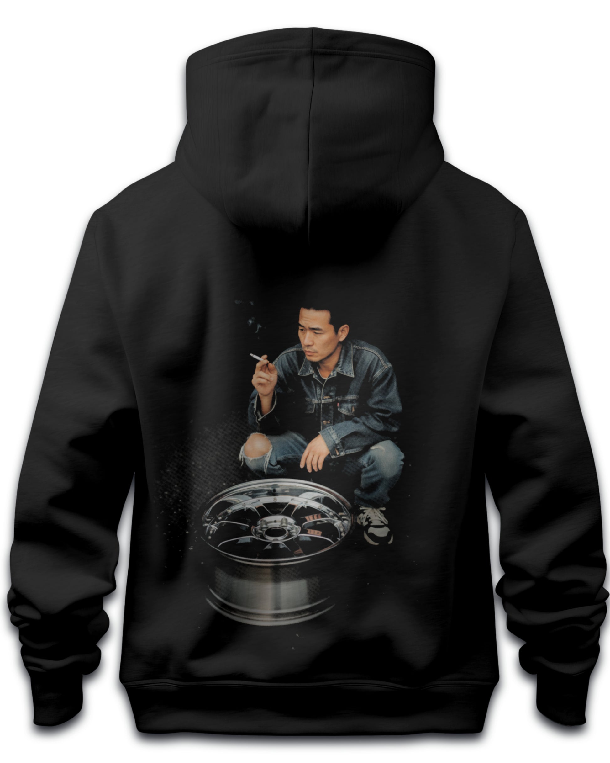 Black hoodie with a graphic of a japanese drifter person crouched over an alloy wheel expressing japanese drift culture on the back, on a white background