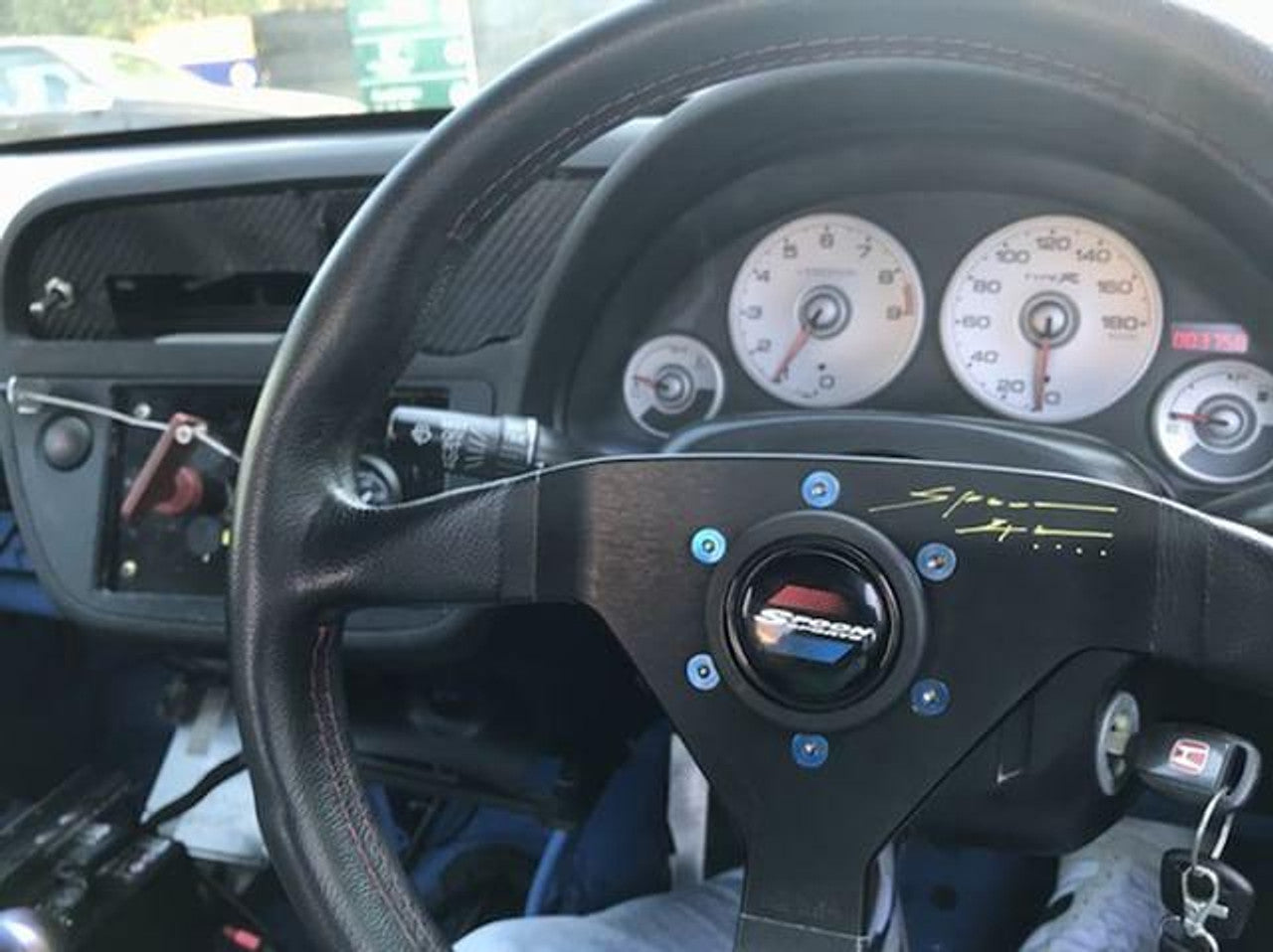 a spoon steering wheel showcasing titanium steering wheel bolts