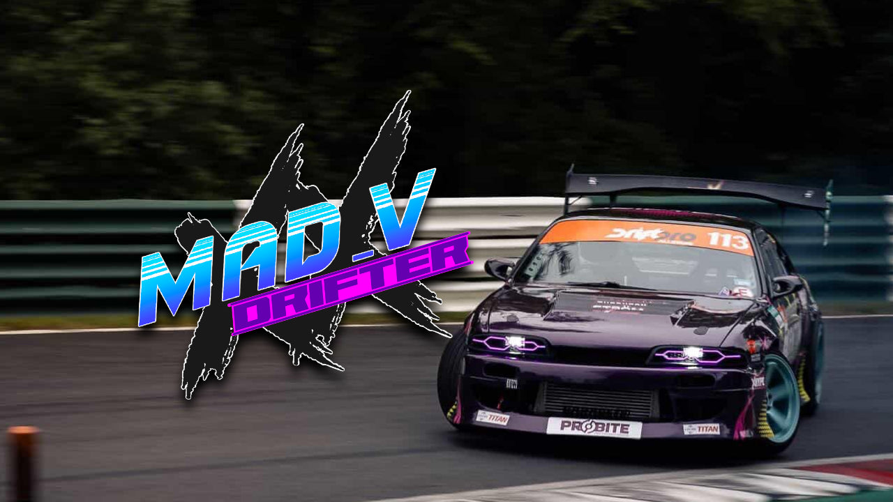 Drifting car on a track with 'MAD V Drifters' logo in the foreground