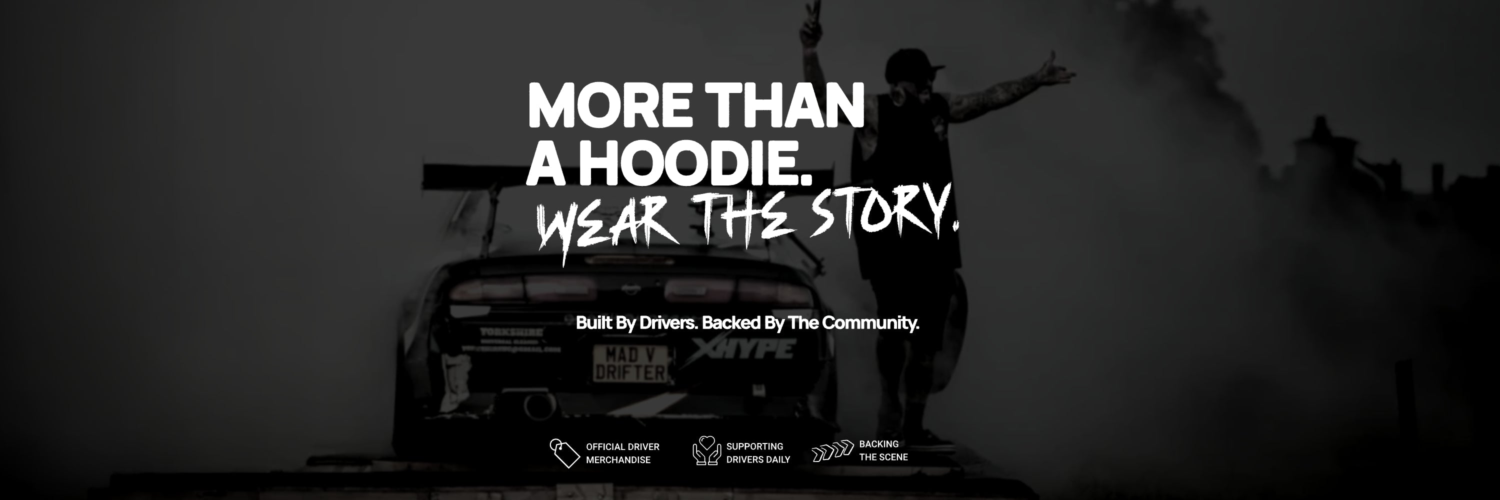 Black and white advertisement with text 'More than a hoodie. Wear the story.' and a person with arms outstretched. NISSAN S14 DRIFT CAR IN BACKGROUND DOING A BURNOUT