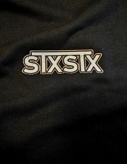 Close-up of a black fabric with 'STX' logo in the center