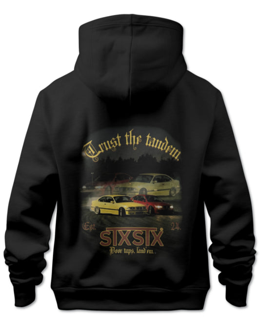 Black Premium  STXSTX hoodie with graphic design of two bmw cars drifting in tandem on a racetrack on the back, on a white background