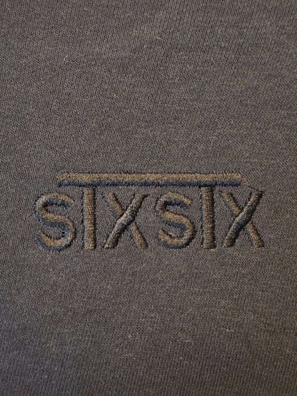 A close up of a black embroidery logo on a hoodie