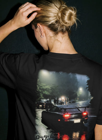 a women model wearing a stxstx premium black tshirt with a mazda rx7 drift car printed on it