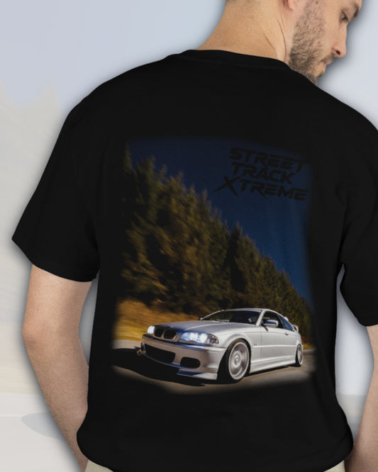 Black premium stxstx t-shirt with a bmw e46 drift car graphic and 'Street Track Xtreme' text on the back, worn by a person.